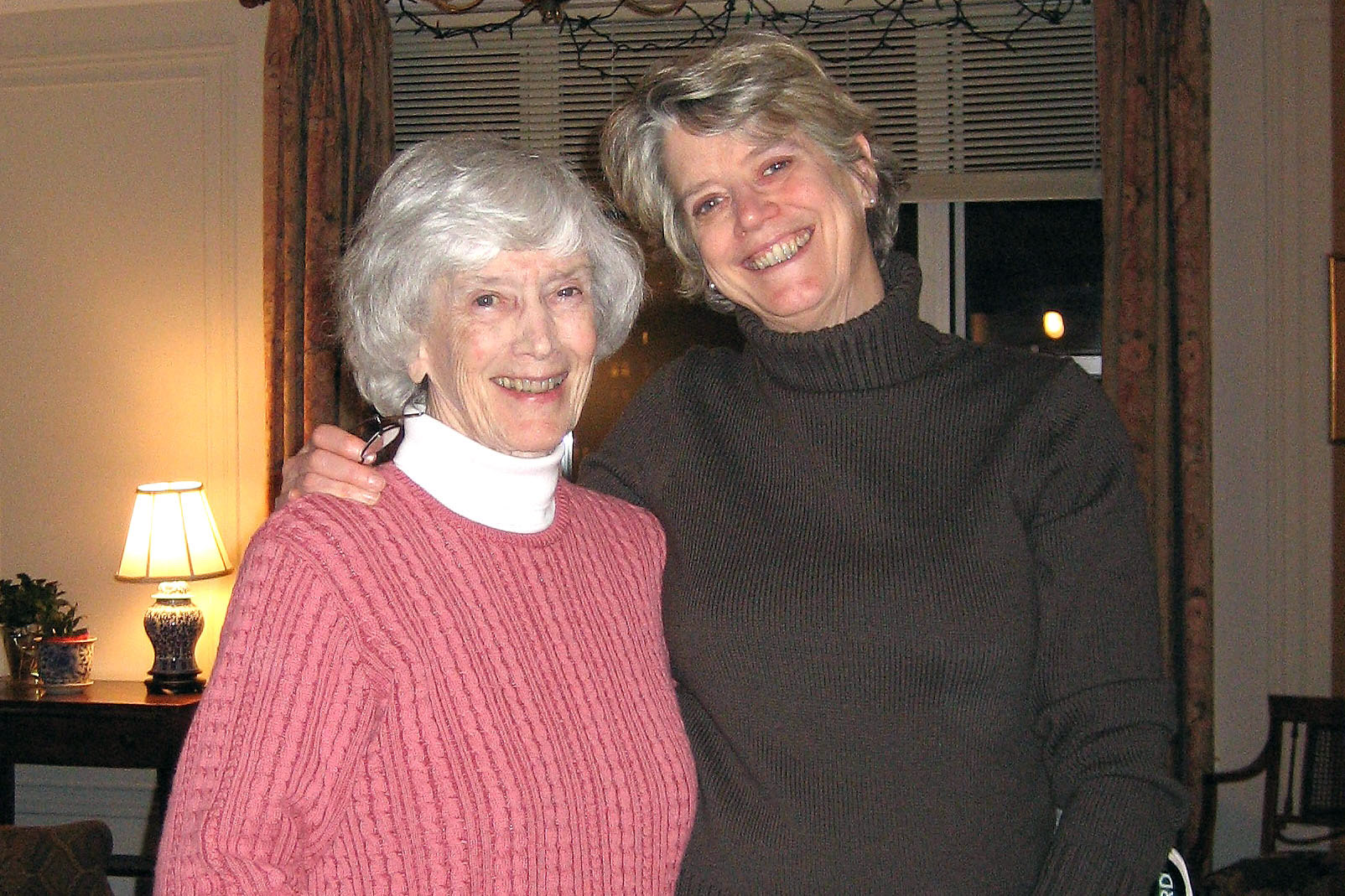 Pictured: Elizabeth “Betty” Gatchell Bouton ’44-45 and her daughter, Katherine Bouton ’69. - Two women standing and smiling for a picture.