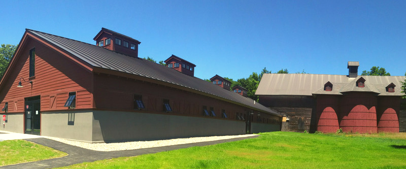 A photo of the Environmental Cooperative: a cluster of long, low barns.