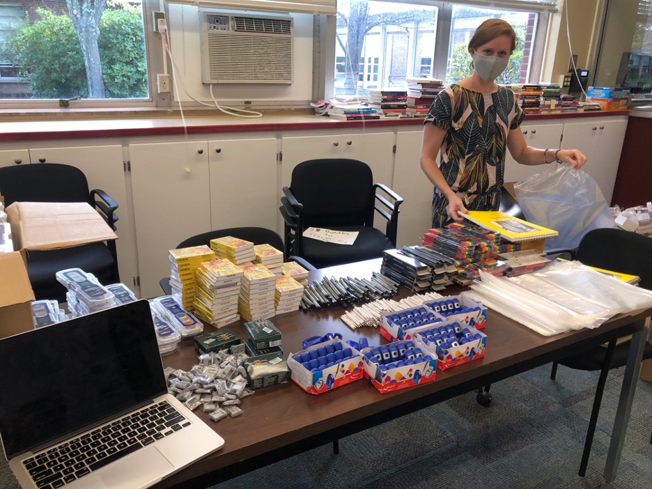 A person stands in front of art supplies.