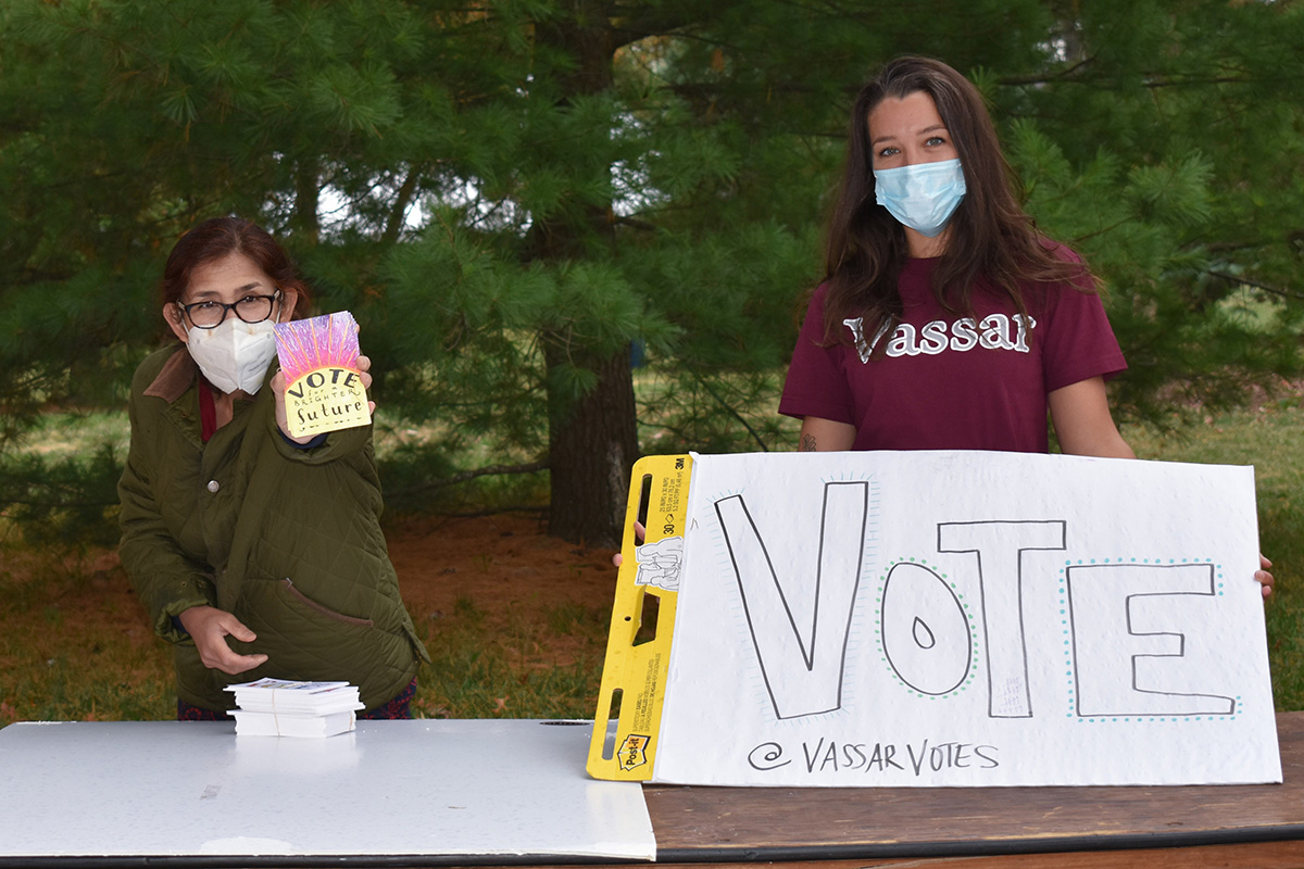 Vassar student holding poster: Vote @VassarVotes