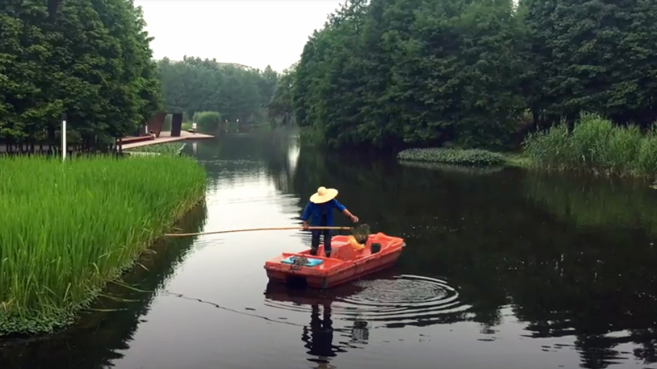 Person guiding a boat on a river
