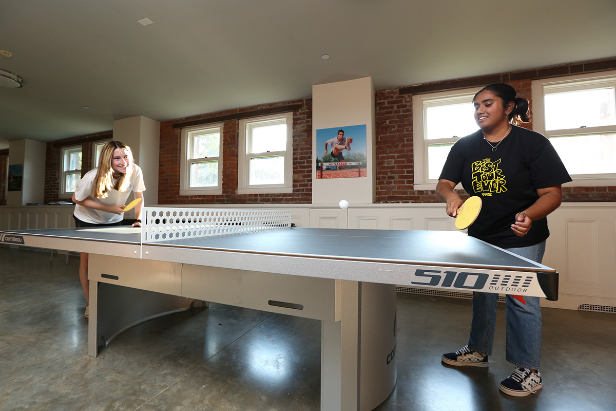 Davison residents Emmie Jensen ’25 (left) and Maryam Bacchus ’25 engage in a fierce ping-pong match in the new game room.