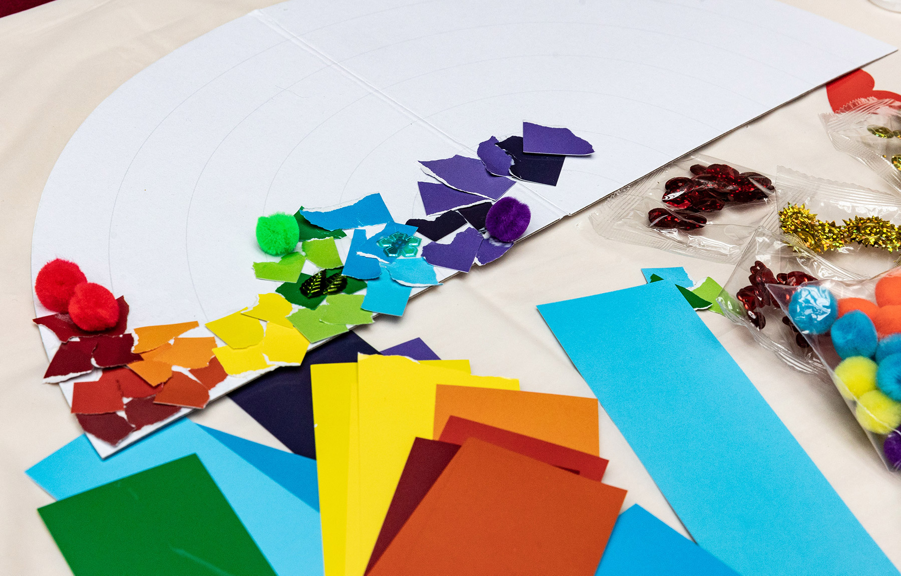 Different colored art supplies scattered on a table