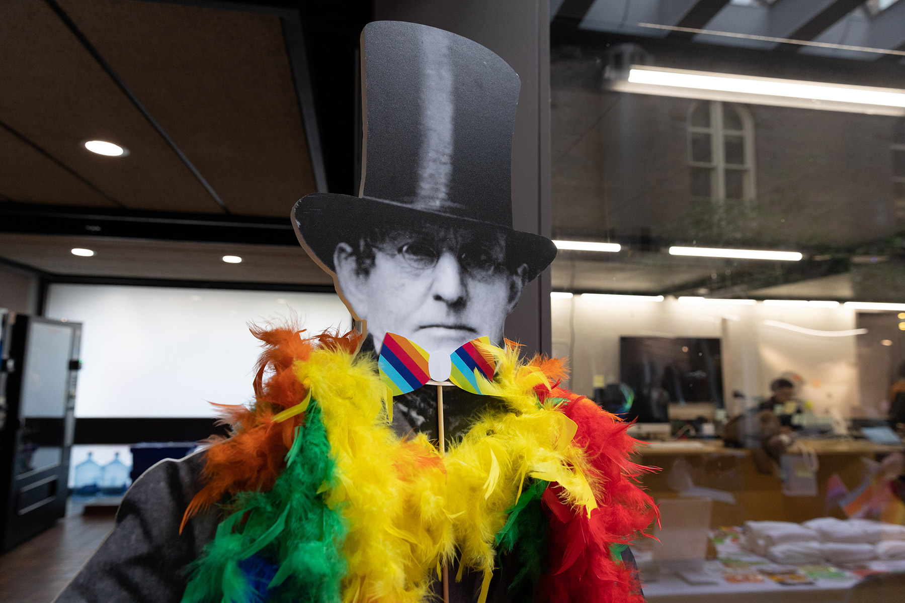 Matthew Vassar cardboard cutout adorned with rainbow lei