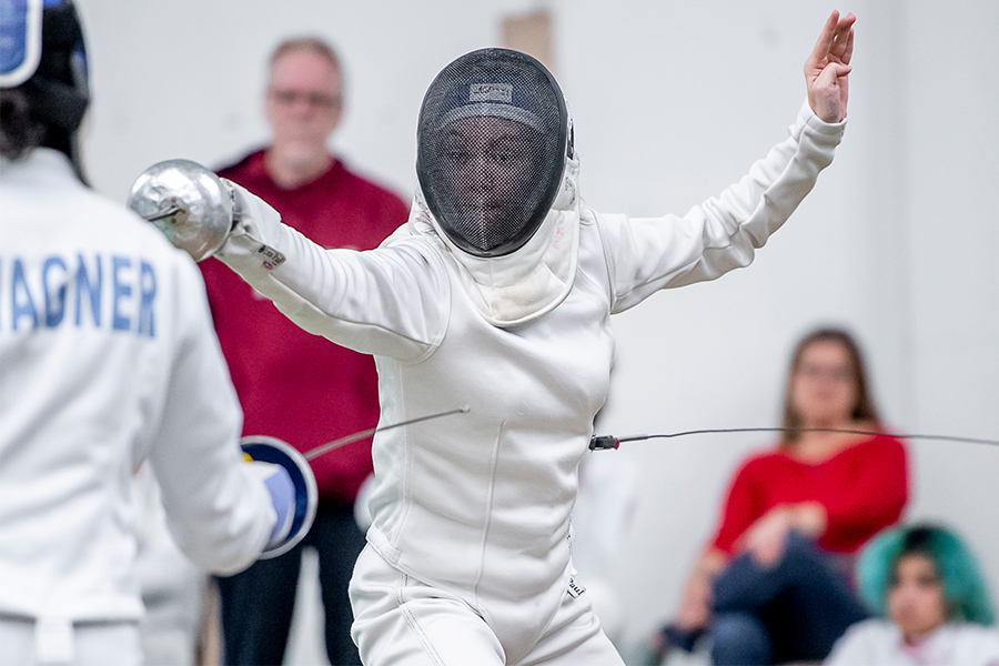 Action shot of Olivia Barnes during a fencing match.