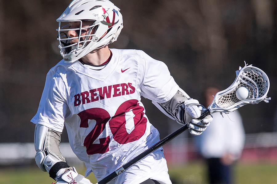 Troy Santise holds the ball in his lacrosse stick.