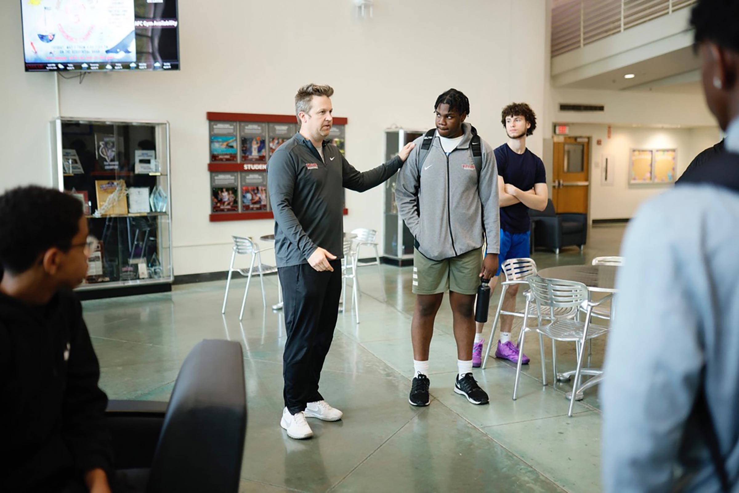 Vassar Men’s Basketball Coach Ryan Mee and Benson talk in the Fitness Center.