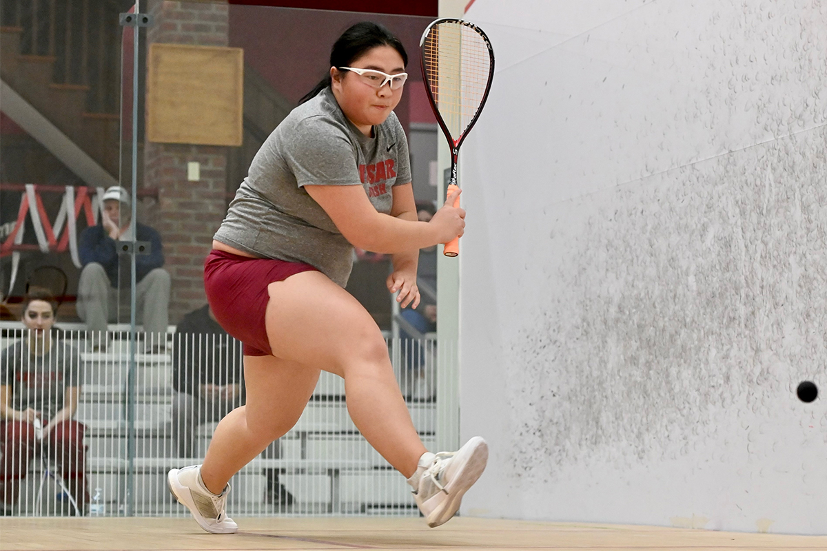 Action shot of Anna Lee stepping forward to hit the ball with her racket