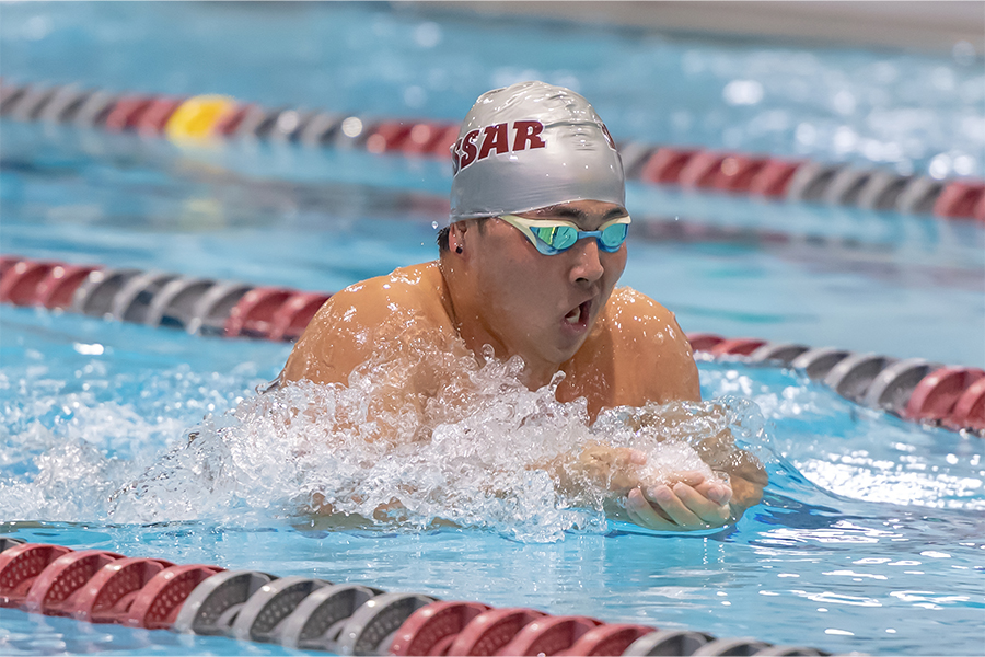 Action shot of Ricky Kurosawa swimming the breaststroke in a pool.