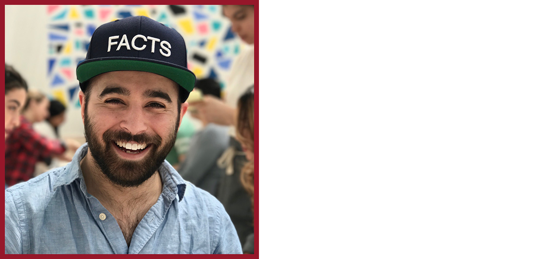 Person with a beard and blue collared dresss shirt wearing a hat that reads, "FACTS".