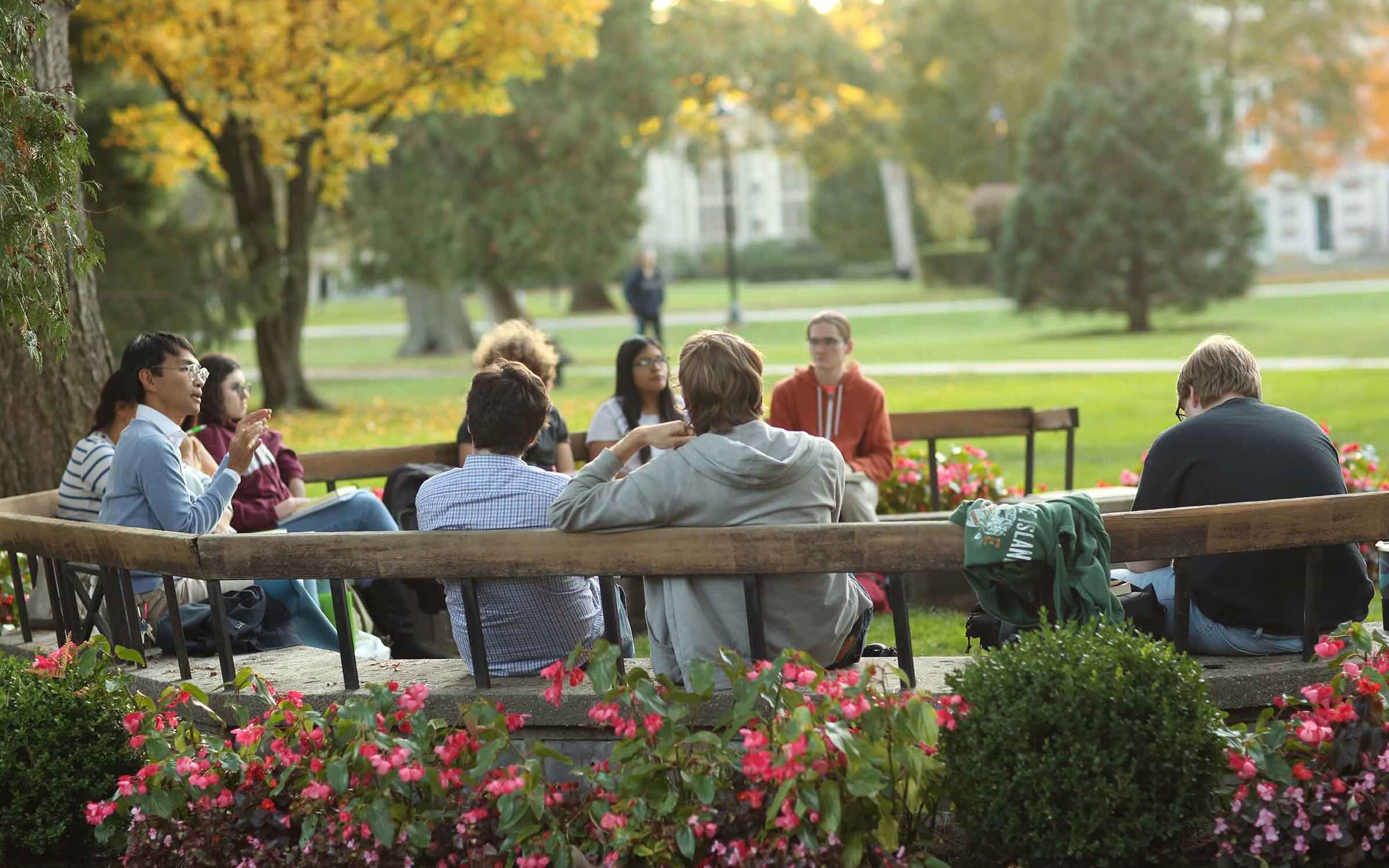A group in an outdoor classroom seated in a circle.