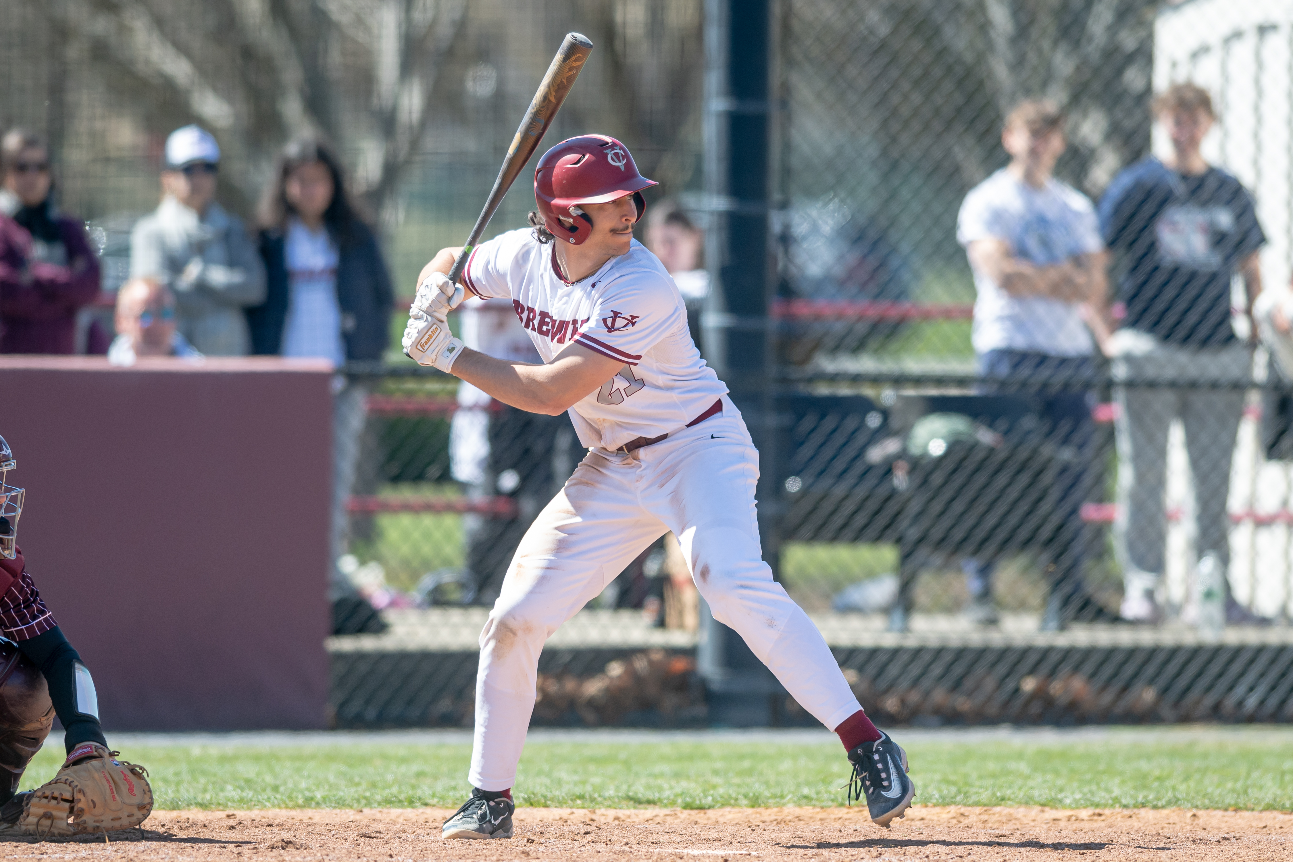 Jack Silvera, holding up his bat, waits for the pitch at home plate.