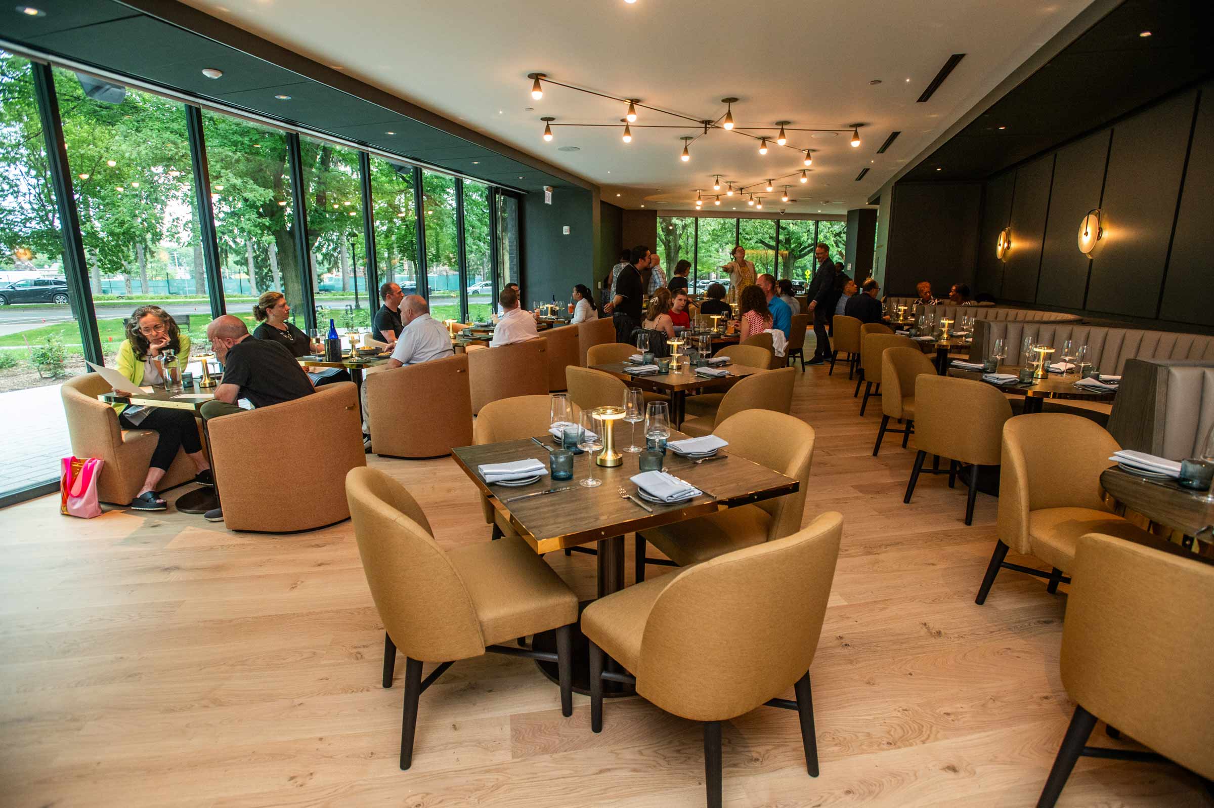 The interior of a dining area with guests looking over their menus.