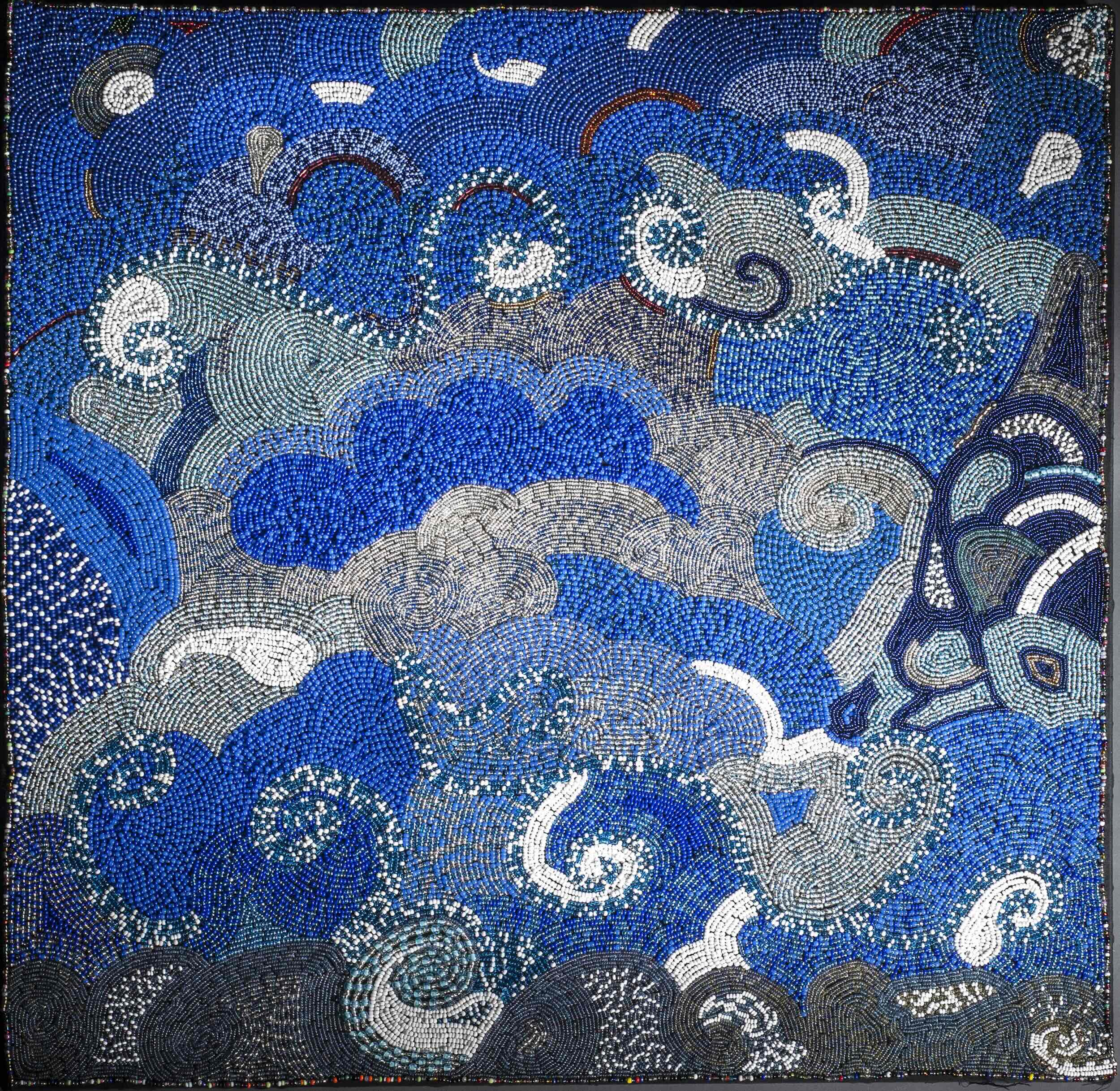 Beadwork of overlapping blue and silver cloud-like forms.