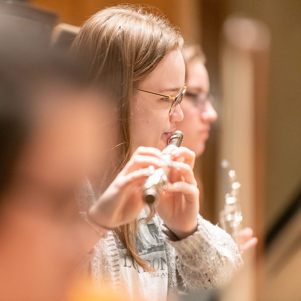 Person on a stage playing a flute.