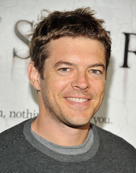 A headshot of Jason Blum, a person with short brown hair and a gray shirt who is smiling at the camera.