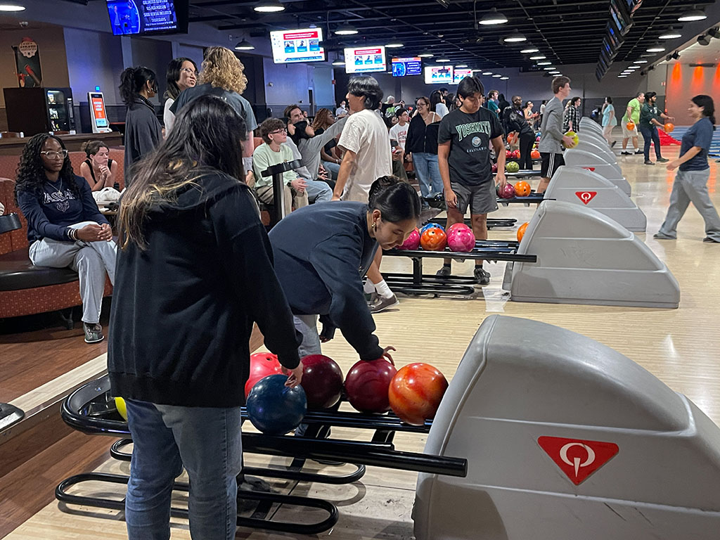 view of bowling lane seating with people