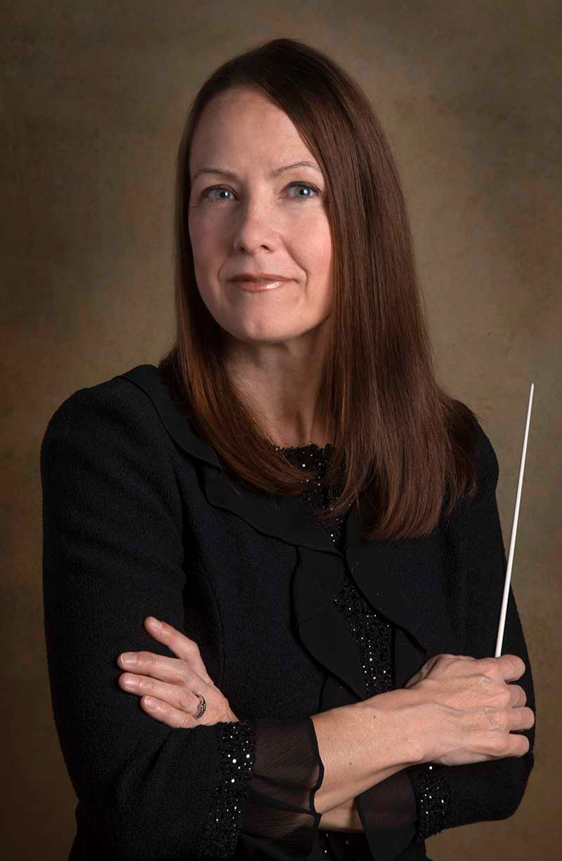 A portrait photo of Christine Howlett, holding a baton.