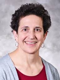 A portrait of Professor Katharine Freeman, a person with short black hair and a gray shirt.