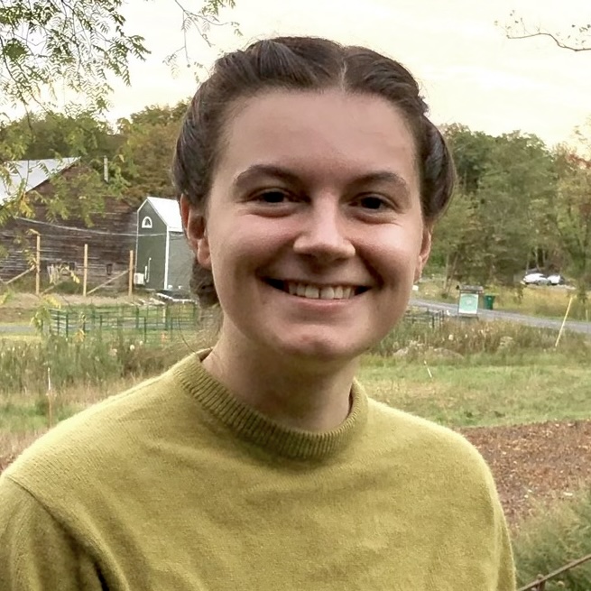 A photo portrait of Kyra Hoffman, a person with short brown hair and a yellow shirt.