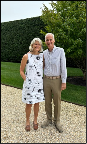 Two people standing side-by-side outside posing for a photo.