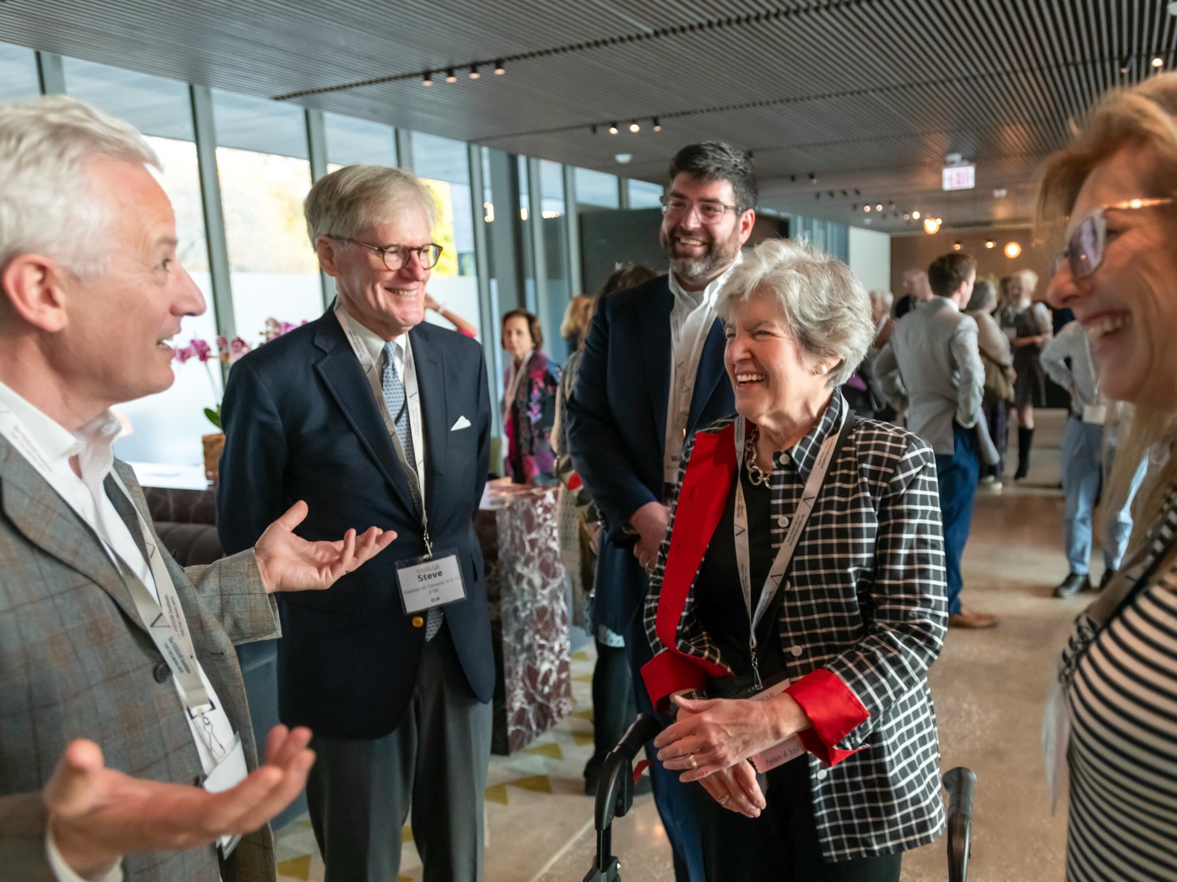 A group of people standing around smilling.