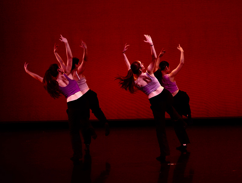 Four dancers performing on stage