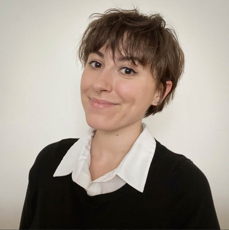 A portrait of Fresia Martinez Olivera, a person with short brown hair and a black shirt.