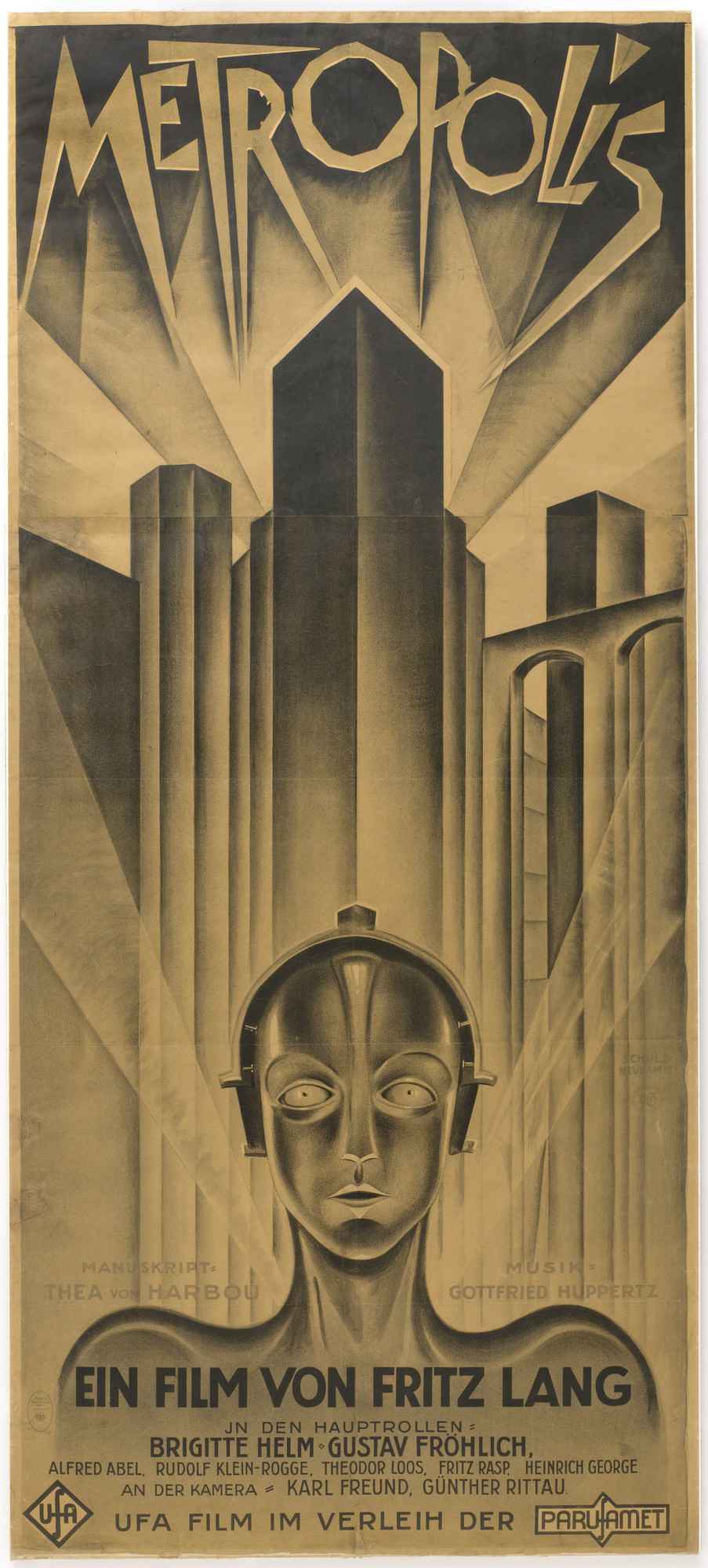 A black and white poster for the 1927 film Metropolis. This is an illustration of an android standing in front of a futuristic city with the word "Metropolis" at the top.