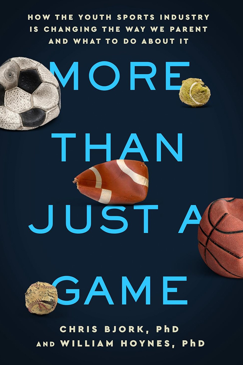 Book jacket for "More Than Just a Game" by Christopher Bjork and William Hoynes, featuring several images of tattered and deflated balls used in various sports.