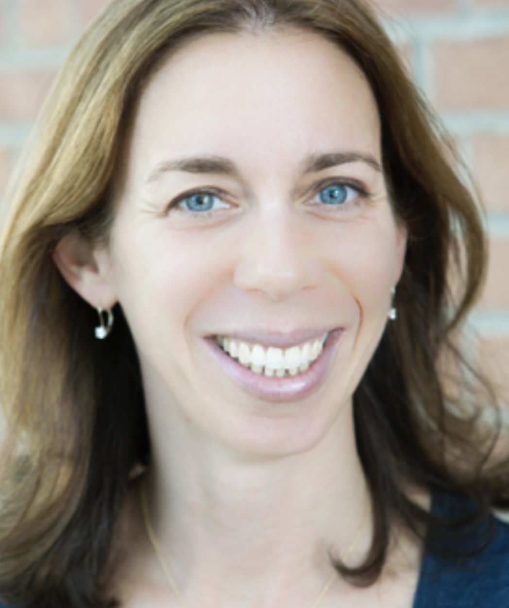 A portrait of Mandy Salva, a person with long brown hair.