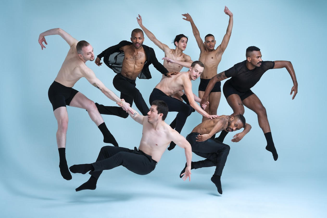 A number of people perform dance moves, posing against a light blue background.