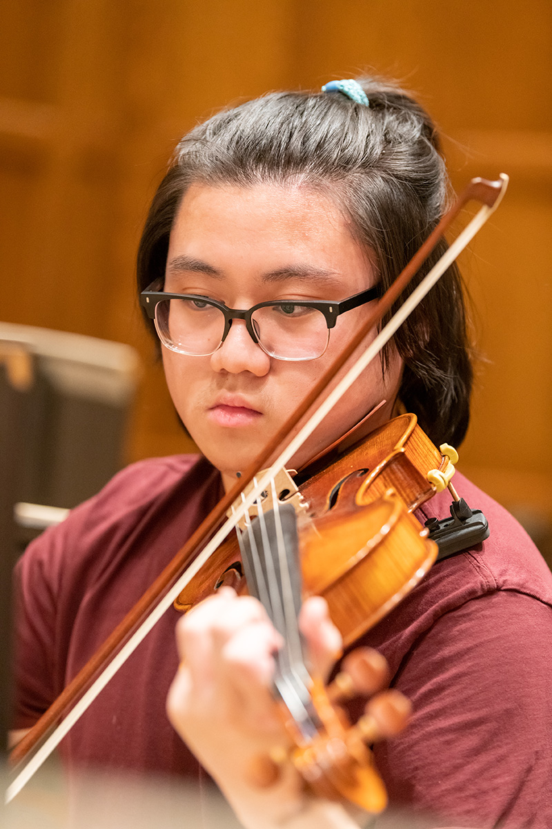 A violinist playing in a rehearsal