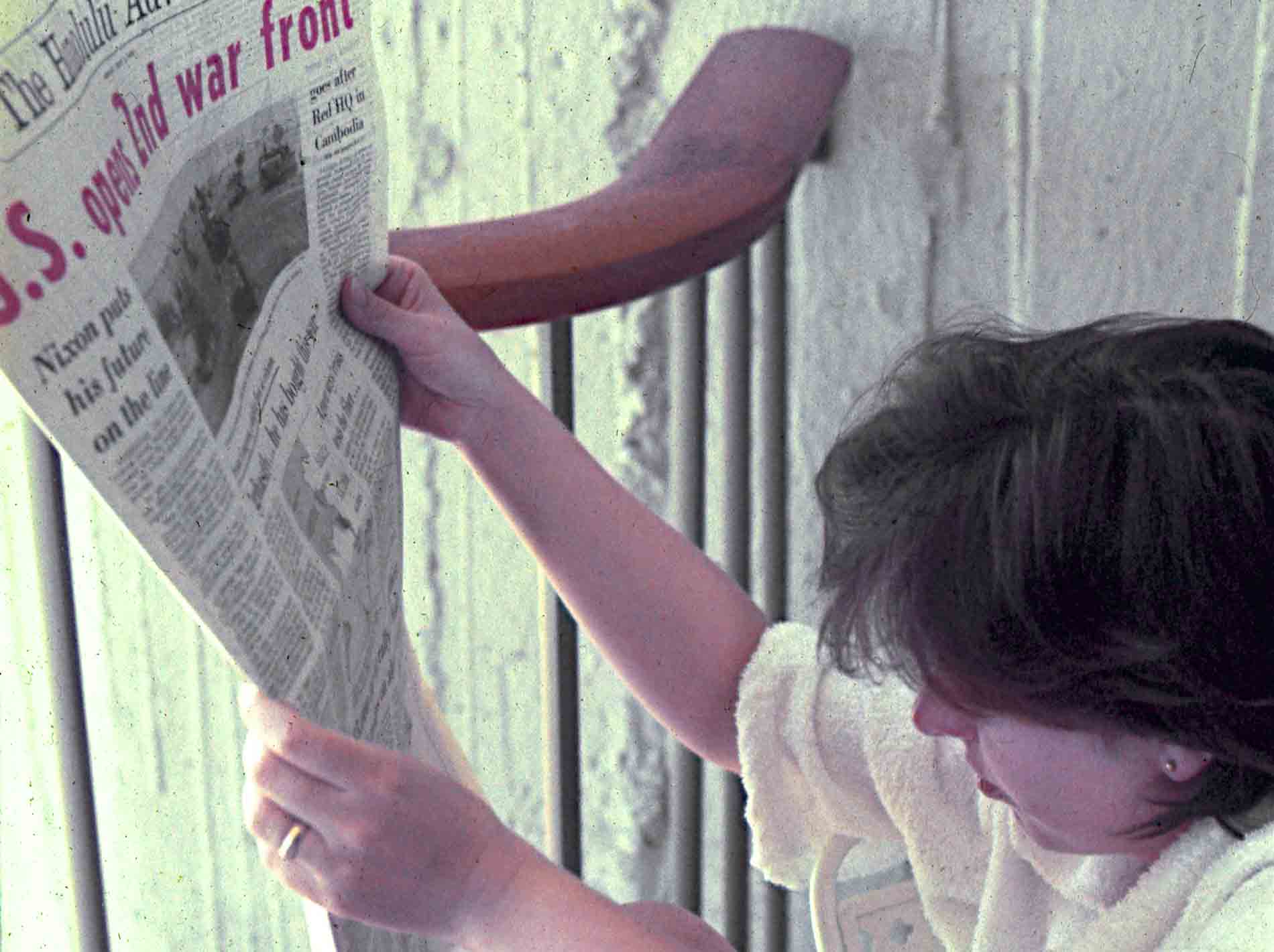 Person holding reading a newspaper with headline that reads: U.S. opens 2nd war front.