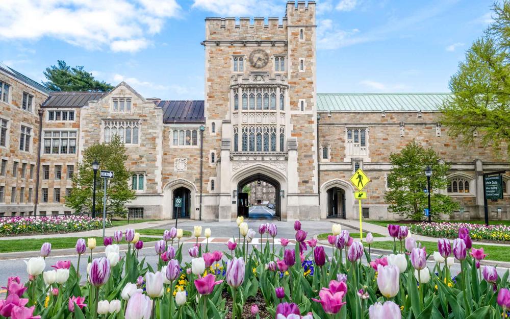 Front of the Taylor Hall Gate: a large stone building with the entrance to campus