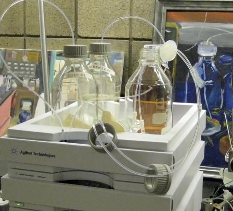 glass bottles in a tray with hoses coming out of them.