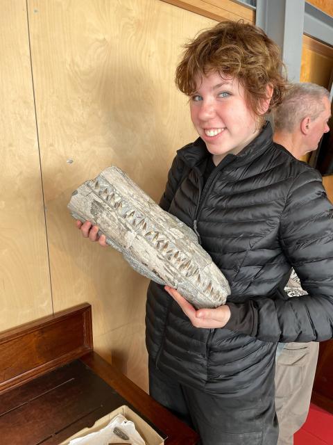 Carter Mucha ’22 examines a marine reptile fossil at the Lyme Regis Museum in England.