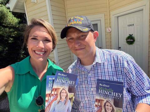 two people holding political pamphlets