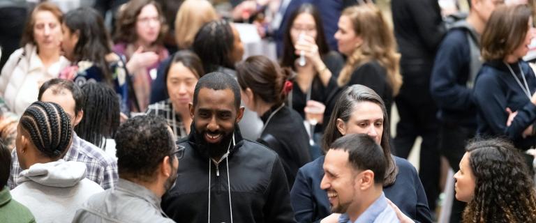 People in a crowd smiling and visiting.