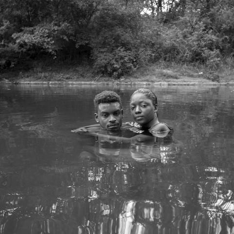 Image of two people in a stream of water