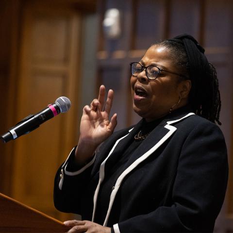 Jen Brown sings at the podium during the MLK Day breakfast in the Villard Room