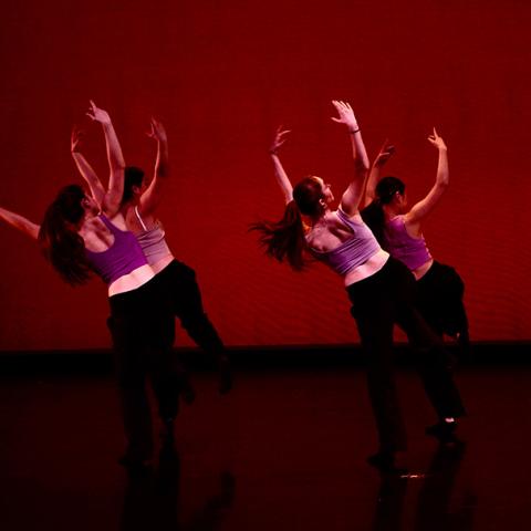 Four dancers performing on stage