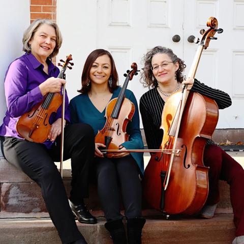 The three artists posing with their instruments.